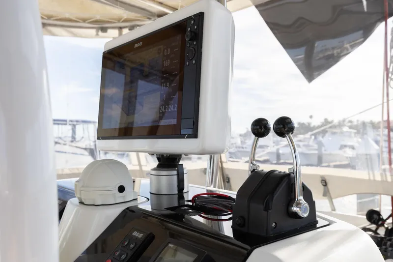 Second Wind Yacht Photos Pics Control panel of a 2022 Lagoon 52 F yacht with navigation display and throttle levers.