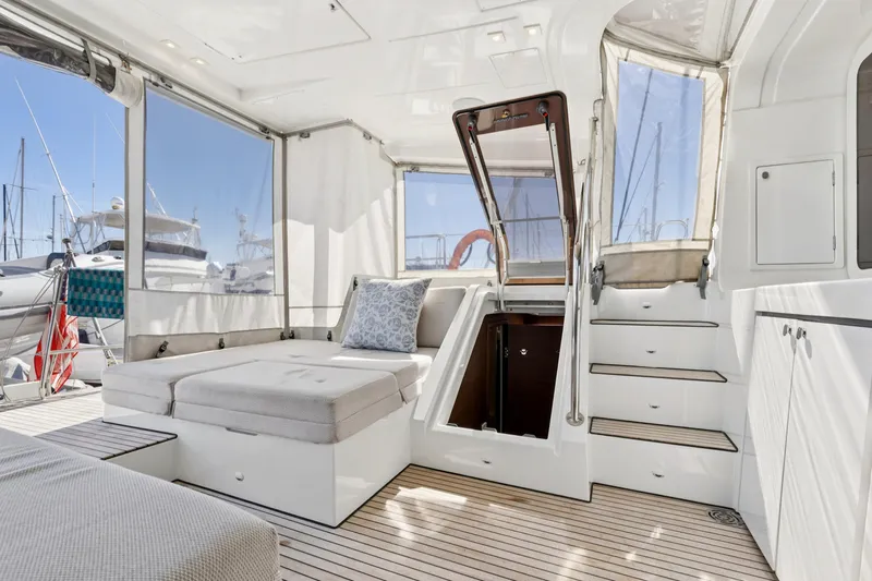 Second Wind Yacht Photos Pics Luxurious interior of 2022 Lagoon 52 F yacht with modern seating and staircase.