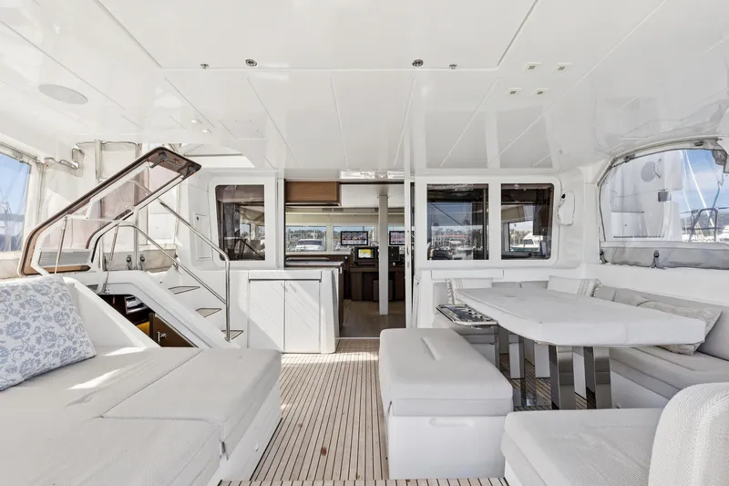 Second Wind Yacht Photos Pics Luxurious interior of 2022 Lagoon 52 F catamaran with modern seating and dining area.