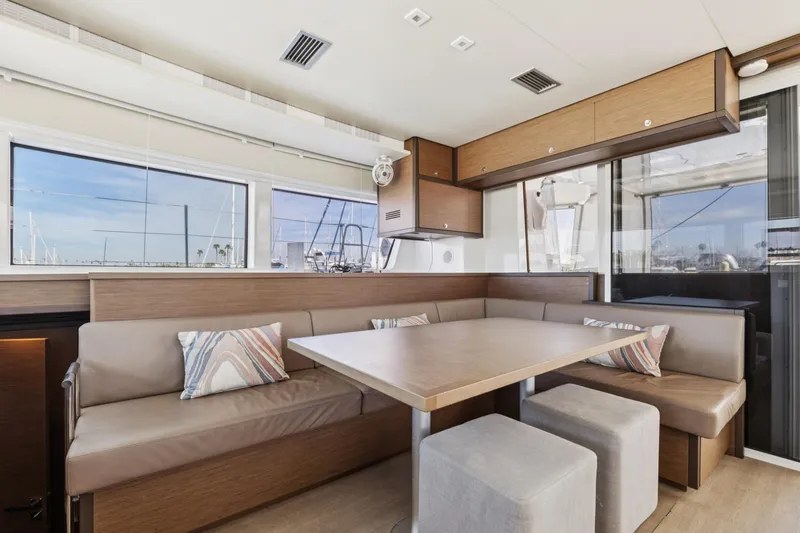 Second Wind Yacht Photos Pics Interior of 2022 Lagoon 52 F yacht with modern dining area and large windows.