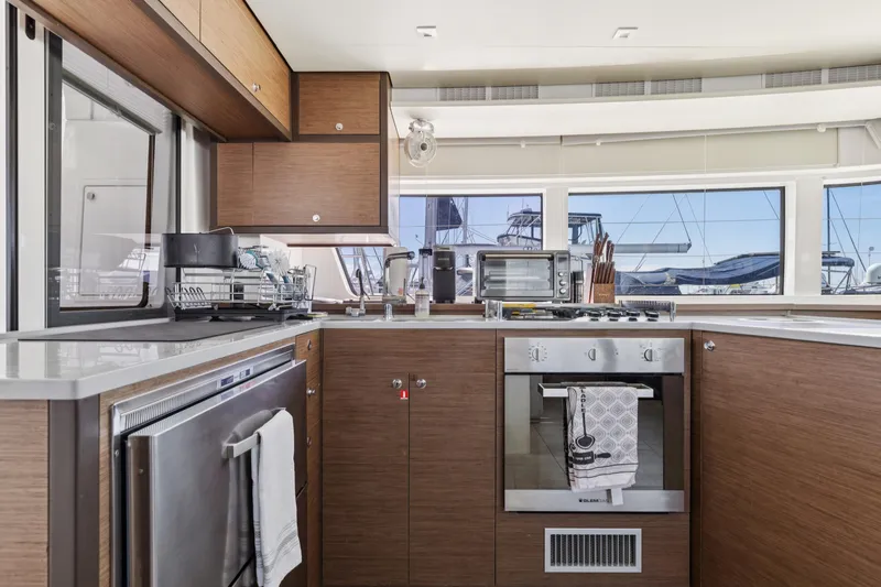 Second Wind Yacht Photos Pics Modern kitchen interior on 2022 Lagoon 52 F yacht with appliances and ocean view.