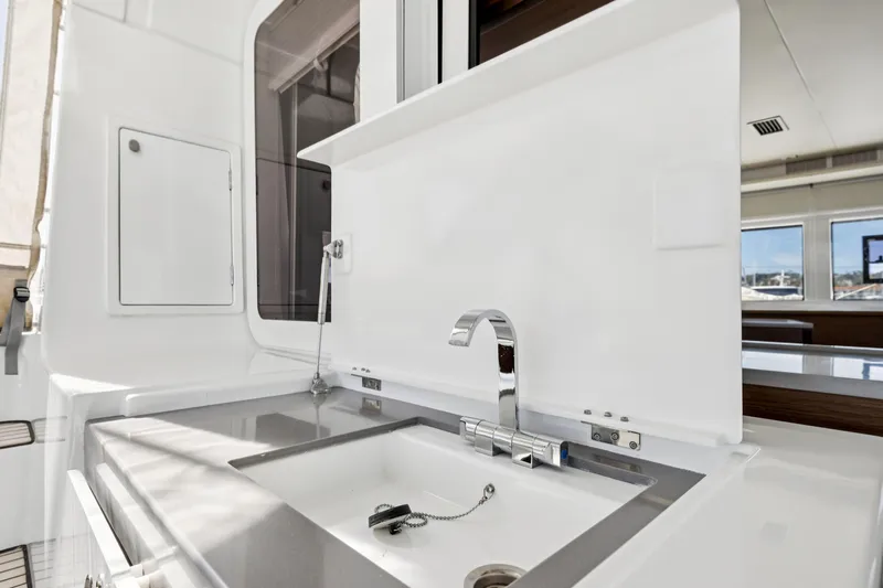 Second Wind Yacht Photos Pics Modern kitchen sink on 2022 Lagoon 52 F yacht, featuring sleek design and chrome faucet.