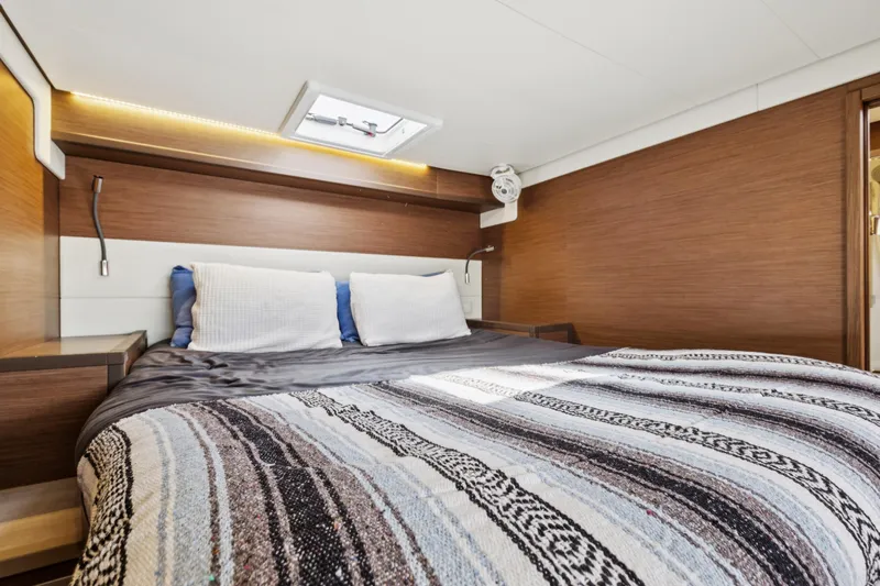 Second Wind Yacht Photos Pics Luxurious cabin interior of 2022 Lagoon 52 F yacht with cozy bedding.