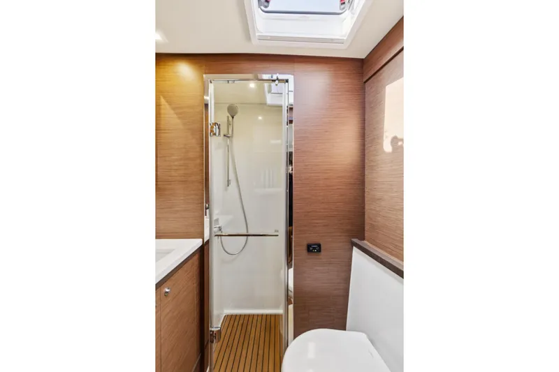 Second Wind Yacht Photos Pics Luxurious bathroom in 2022 Lagoon 52 F yacht with modern shower and wooden accents.