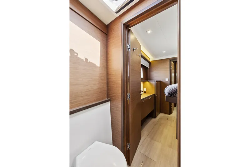 Second Wind Yacht Photos Pics Interior of 2022 Lagoon 52 F yacht, featuring modern wood finishes and cozy cabin space.