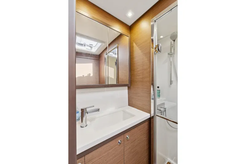 Second Wind Yacht Photos Pics Modern bathroom in 2022 Lagoon 52 F yacht with sleek fixtures and wood accents.