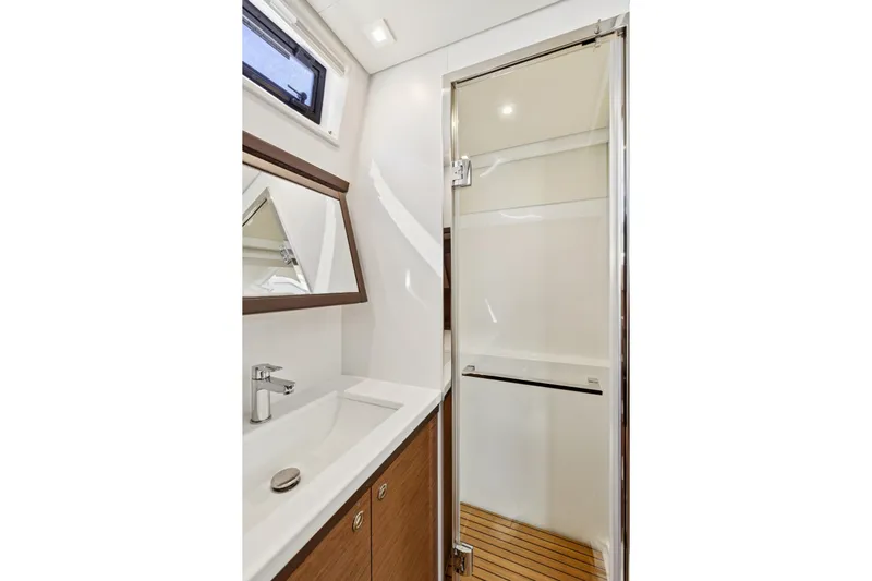 Second Wind Yacht Photos Pics Luxurious bathroom in 2022 Lagoon 52 F yacht with modern fixtures and wooden accents.