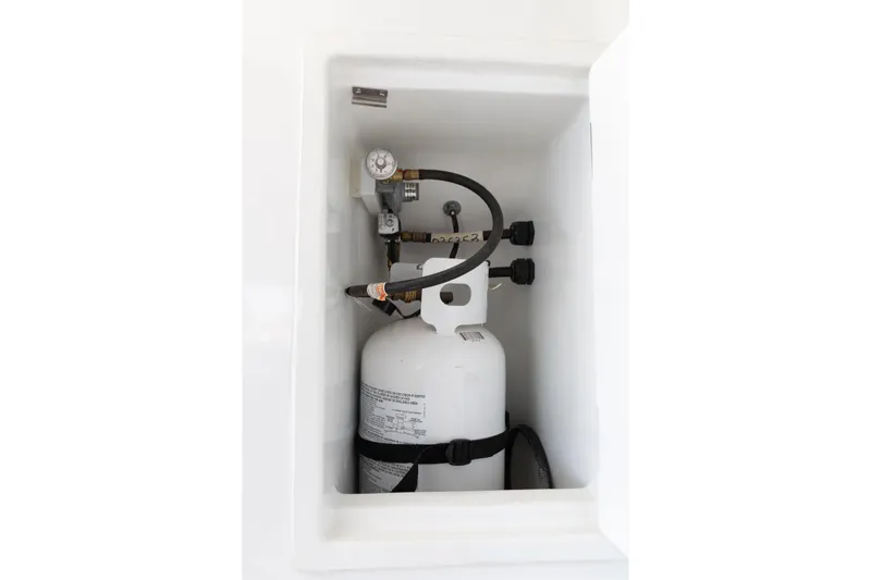 Second Wind Yacht Photos Pics Propane tank compartment on 2022 Lagoon 52 F yacht, featuring secure fittings and connections.