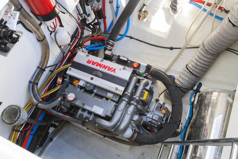 Second Wind Yacht Photos Pics Engine compartment of a 2022 Lagoon 52 F yacht with Yanmar engine and various components.