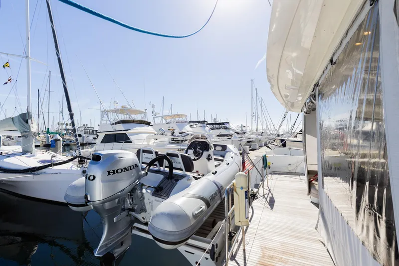 Second Wind Yacht Photos Pics 2022 Lagoon 52 F yacht docked with inflatable boat and Honda motor.