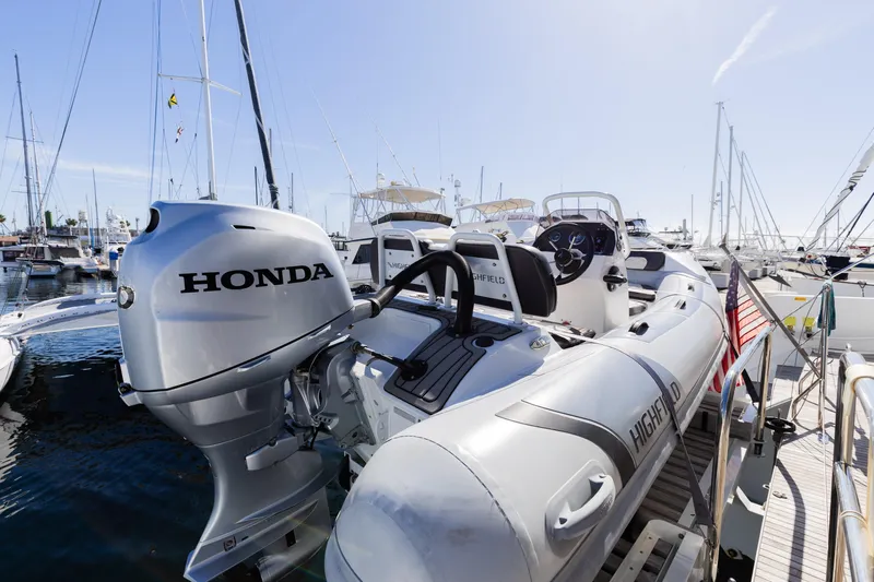 Second Wind Yacht Photos Pics Lagoon 52 F 2022 yacht with Honda outboard motor and Highfield tender at marina.