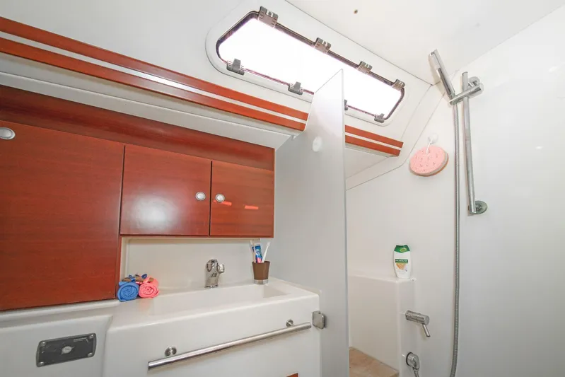  Yacht Photos Pics Bathroom interior of 2006 Hanse 400 yacht with wooden cabinets and shower area.