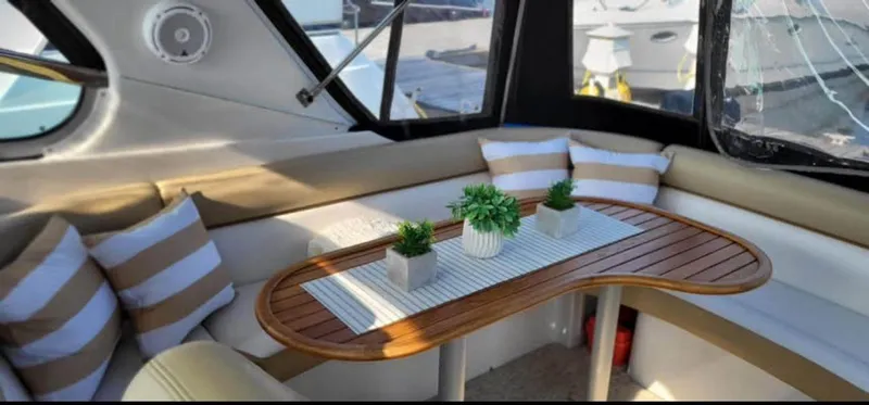  Yacht Photos Pics Interior of 2009 Four Winns 378 Vista yacht with cushioned seating and wooden table.