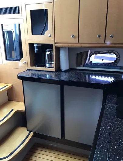  Yacht Photos Pics 2009 Four Winns 378 Vista yacht interior with modern kitchen and wooden cabinetry.