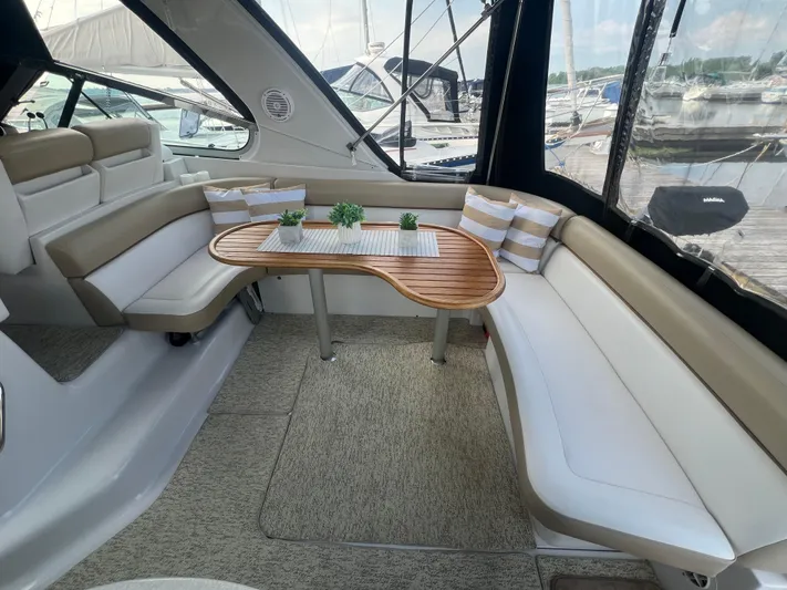  Yacht Photos Pics 2009 Four Winns 378 Vista yacht interior with elegant seating and wooden table.