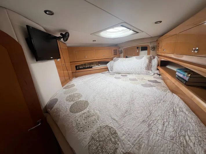  Yacht Photos Pics Cozy cabin interior of 2009 Four Winns 378 Vista with bed, TV, and storage cabinets.