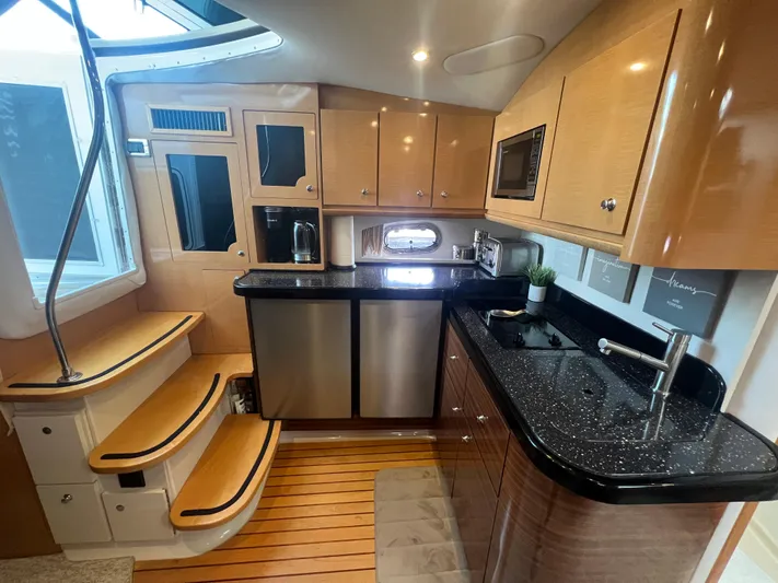  Yacht Photos Pics Luxurious 2009 Four Winns 378 Vista yacht interior with modern kitchen and wooden flooring.