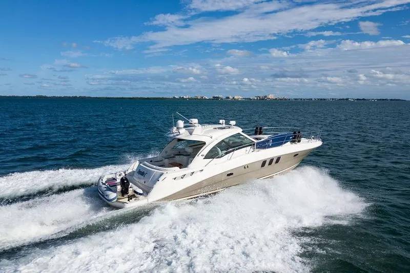  Yacht Photos Pics 2005 Sea Ray 48 Sundancer cruising on open water under a clear blue sky.