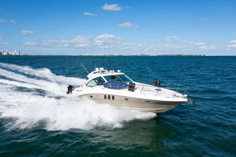  Yacht Photos Pics 2005 Sea Ray 48 Sundancer cruising on open water under a clear blue sky.