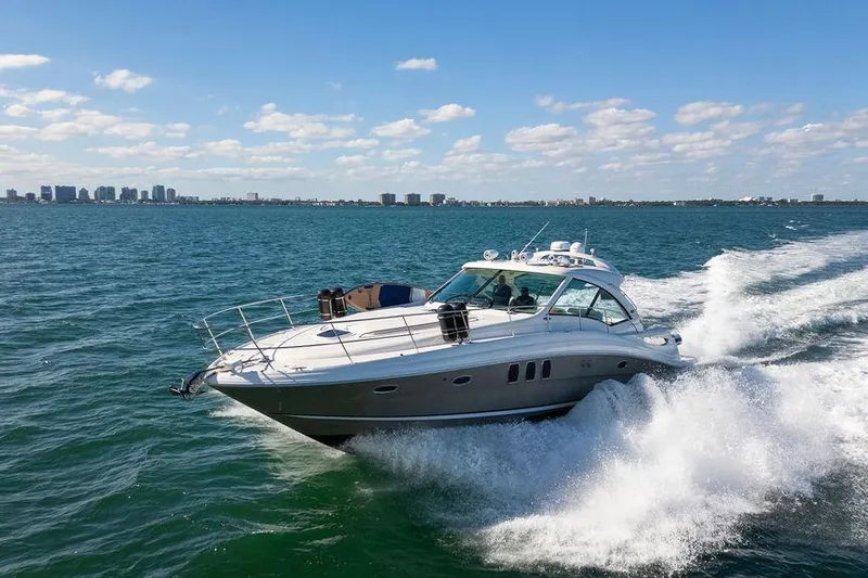  Yacht Photos Pics 2005 Sea Ray 48 Sundancer cruising on open water under a clear blue sky.