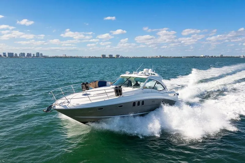  Yacht Photos Pics 2005 Sea Ray 48 Sundancer yacht cruising on open water under a clear blue sky.