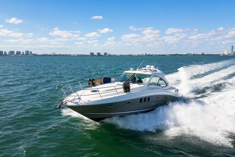  Yacht Photos Pics 2005 Sea Ray 48 Sundancer cruising on open water under a clear blue sky.