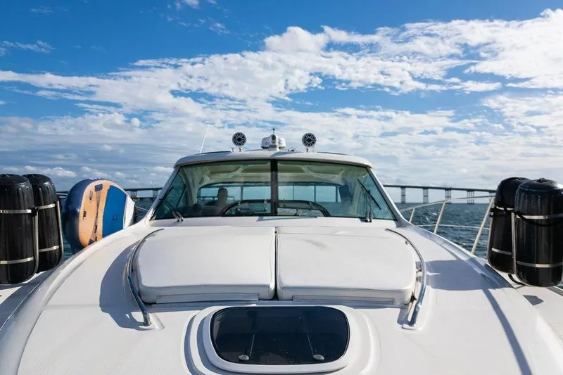  Yacht Photos Pics 2005 Sea Ray 48 Sundancer yacht cruising under a blue sky with clouds.