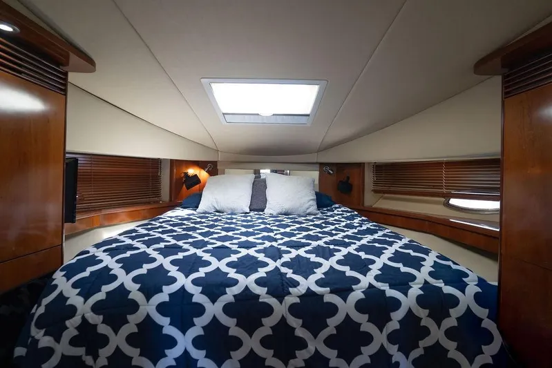  Yacht Photos Pics Luxurious cabin interior of 2005 Sea Ray 48 Sundancer yacht with cozy bedding.