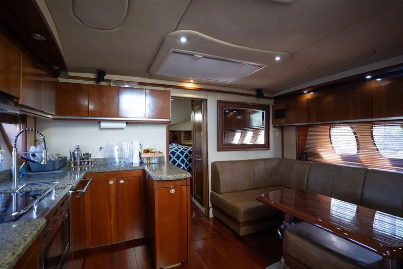  Yacht Photos Pics Luxurious interior of 2005 Sea Ray 48 Sundancer yacht with kitchen and seating area.