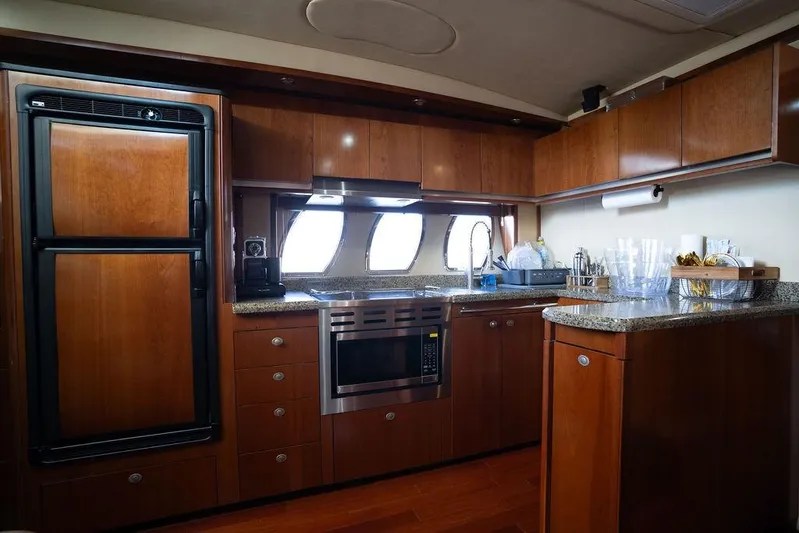  Yacht Photos Pics Luxurious 2005 Sea Ray 48 Sundancer yacht kitchen with wood cabinetry and modern appliances.