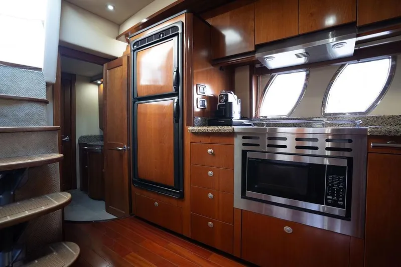  Yacht Photos Pics Luxurious 2005 Sea Ray 48 Sundancer yacht kitchen with wood cabinetry and modern appliances.