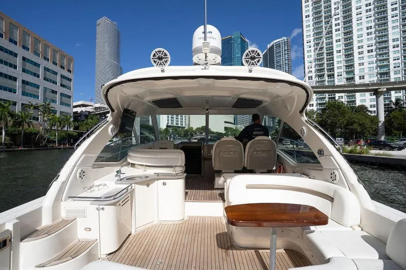  Yacht Photos Pics 2005 Sea Ray 48 Sundancer yacht with spacious deck, docked in urban marina.