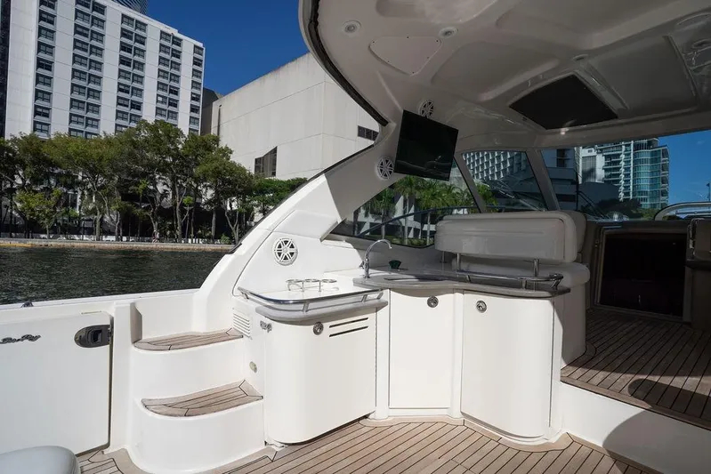  Yacht Photos Pics Luxurious 2005 Sea Ray 48 Sundancer yacht interior with kitchenette and cityscape view.