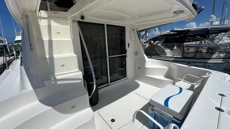 Get N Free Yacht Photos Pics 2006 Sea Ray 44 Sedan Bridge yacht deck with seating and sliding door.