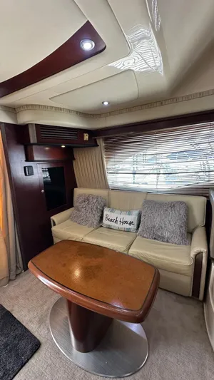 Get N Free Yacht Photos Pics Interior of 2006 Sea Ray 44 Sedan Bridge with sofa, table, and "Beach House" pillow.