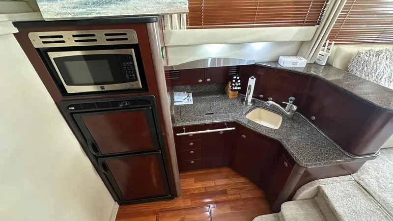 Get N Free Yacht Photos Pics Luxurious kitchen in 2006 Sea Ray 44 Sedan Bridge yacht with modern appliances and wood flooring.