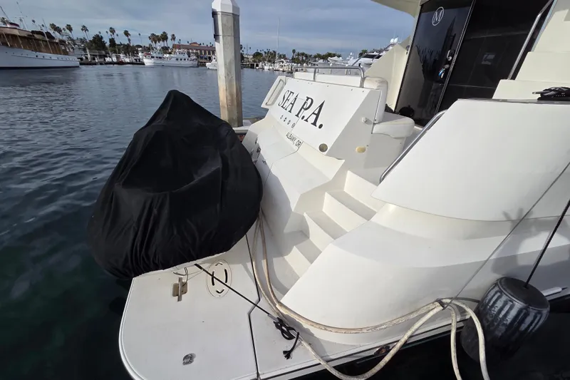 Sea Pa Yacht Photos Pics 2007 Marquis 55 LS yacht docked at marina, rear view with covered equipment.
