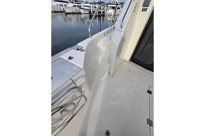 Sea Pa Yacht Photos Pics 2007 Marquis 55 LS yacht deck with stainless steel railings and marina view.