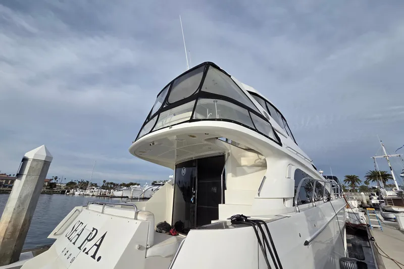 Sea Pa Yacht Photos Pics 2007 Marquis 55 LS yacht docked at marina under cloudy sky.