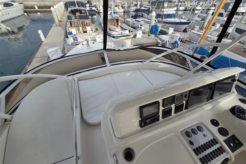 Sea Pa Yacht Photos Pics 2007 Marquis 55 LS yacht helm with marina view, featuring navigation controls and seating.