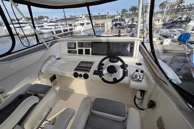 Sea Pa Yacht Photos Pics Helm of 2007 Marquis 55 LS yacht with modern controls and marina view.
