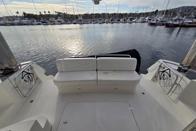 Sea Pa Yacht Photos Pics 2007 Marquis 55 LS yacht stern view at marina, featuring white seating and calm waters.