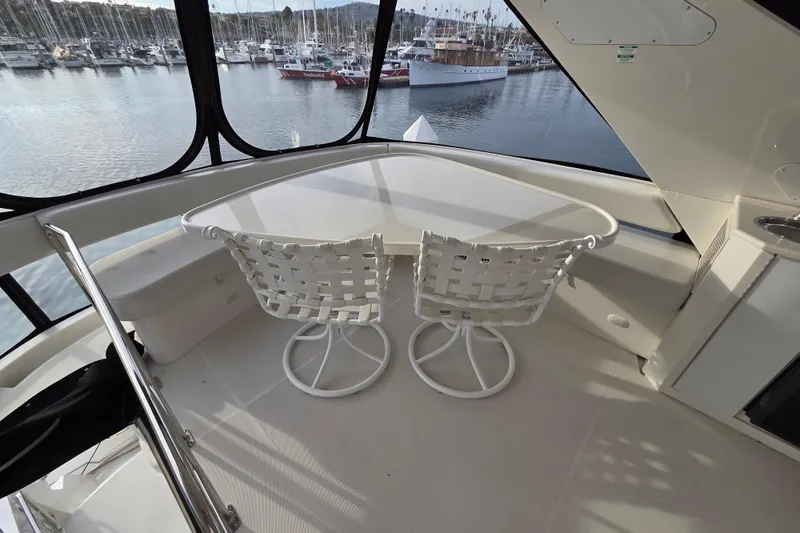 Sea Pa Yacht Photos Pics 2007 Marquis 55 LS yacht interior with table and chairs, overlooking marina.