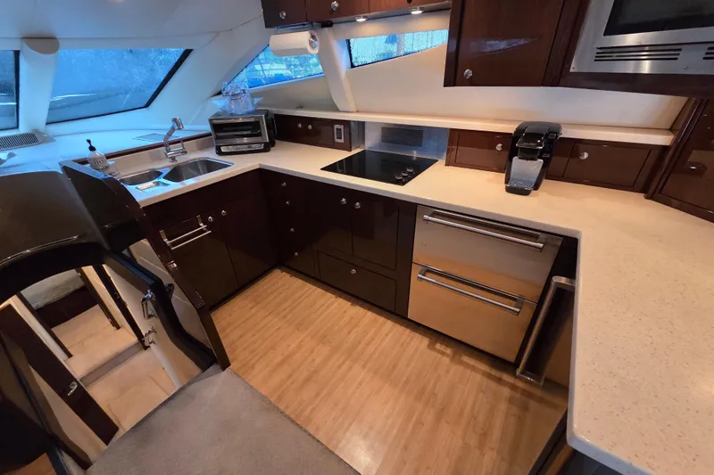Sea Pa Yacht Photos Pics Luxurious kitchen interior of 2007 Marquis 55 LS yacht with modern appliances and sleek design.