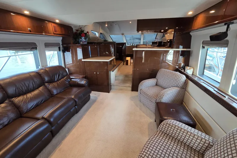 Sea Pa Yacht Photos Pics Luxurious interior of a 2007 Marquis 55 LS yacht with leather seating and elegant wood finishes.