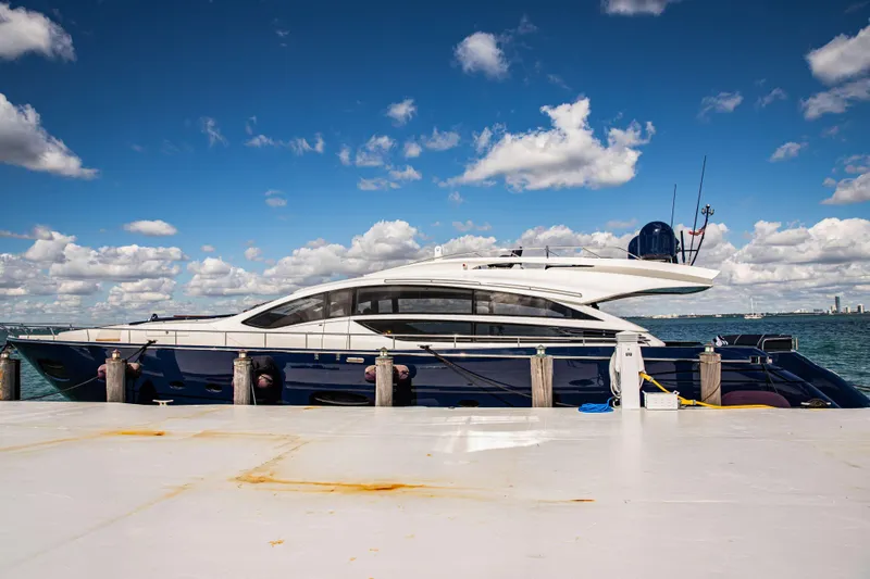 Dorothy Ann Yacht Photos Pics Luxury 2012 Pershing 82 yacht docked under a vibrant blue sky.