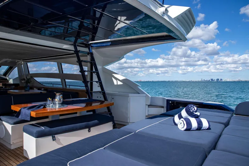 Dorothy Ann Yacht Photos Pics Luxurious 2012 Pershing 82 yacht interior with ocean view, featuring elegant seating and dining area.