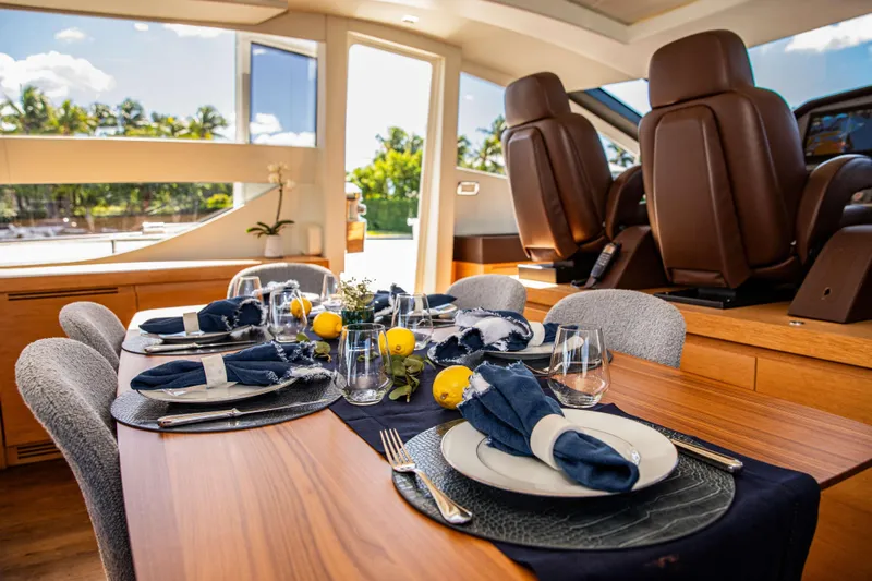 Dorothy Ann Yacht Photos Pics Luxurious dining setup on a 2012 Pershing 82 yacht, featuring elegant tableware and decor.