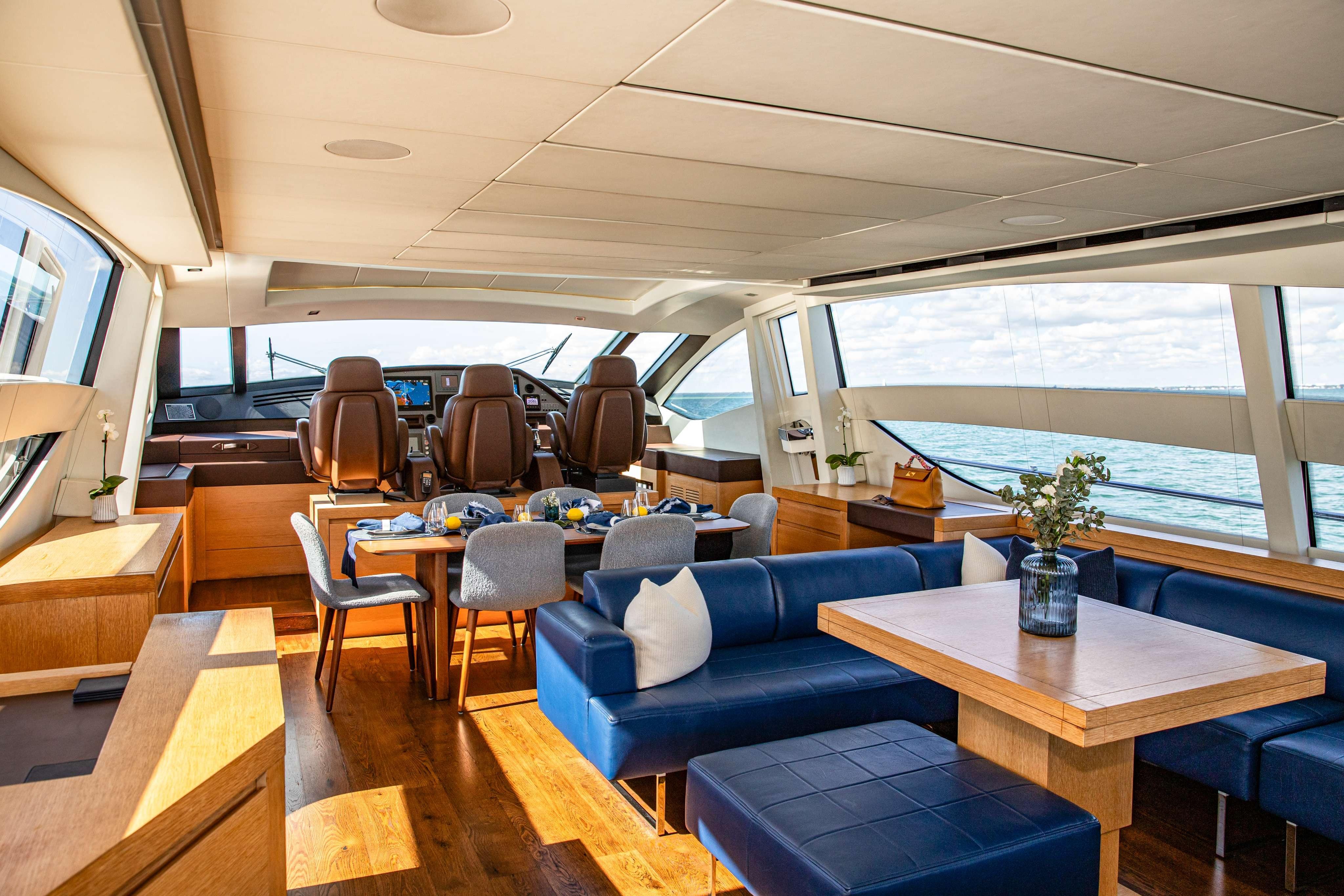 Luxurious interior of 2012 Pershing 82 yacht with elegant seating and dining area.