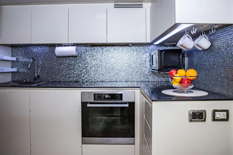 Dorothy Ann Yacht Photos Pics Modern kitchen in 2012 Pershing 82 yacht with sleek design and fruit bowl.